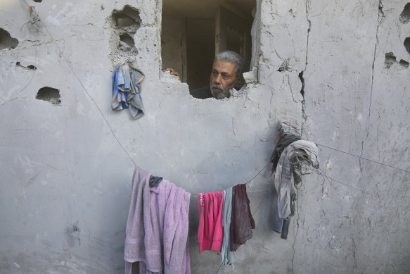 A Palestinian looks on from his house damaged by Israeli airstrikes in Rafah, southern Gaza Strip.