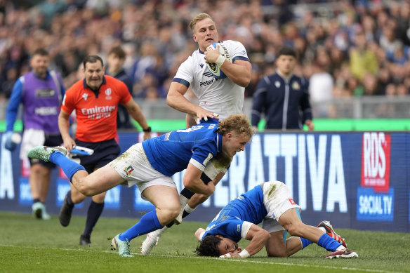Scotland’s Duhan Van Der Merwe is tackled by Italy’s Louis Lynagh.