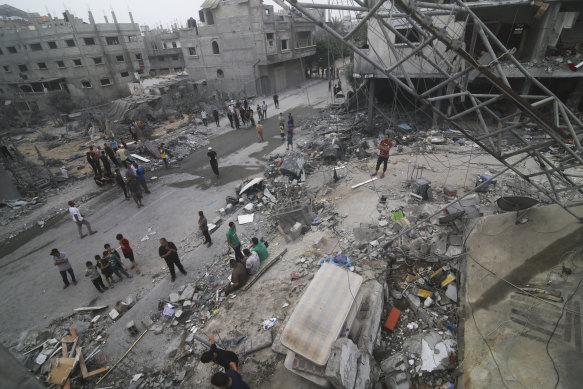 Palestinians look for survivors after an airstrike in Rafah on Monday.