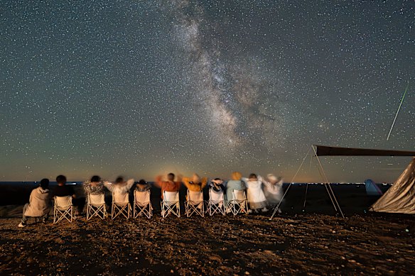 A group of families and friends from China’s Hebei province watch the Perseid meteor shower at  Dahongshan in China’s Inner Mongolia region.