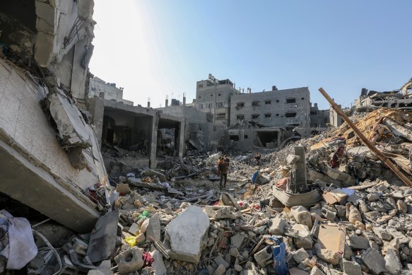 People search through buildings that were destroyed during Israeli air raids in the southern Gaza Strip this week.