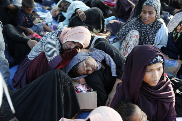 Rohingya women and children rest under a tent after landing on a beach in Kuala Besar, North Sumatra, Indonesia.
