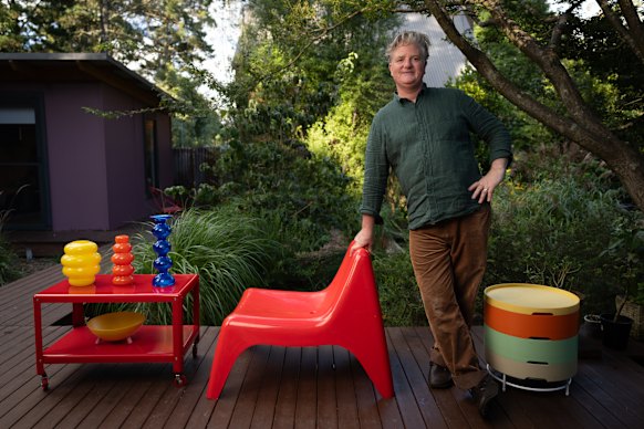 Matthew Sullivan with some of his vintage IKEA pieces, including the Anne Nilsson-designed glassware, IKEA PS 2014 On the Move side table designed by T. Richardson, C. Brill & A. Williams, Ola Wihlborg Postmodern PS Series Bowl (yellow) and easychair Vågö, designed by Thomas Sandell. 