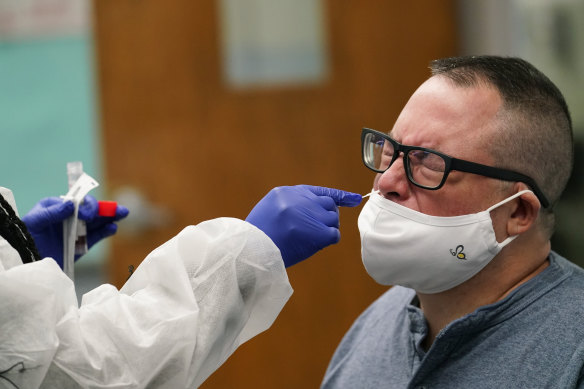 A teacher receives a COVID-19 test at West Brooklyn Community High School in New York.