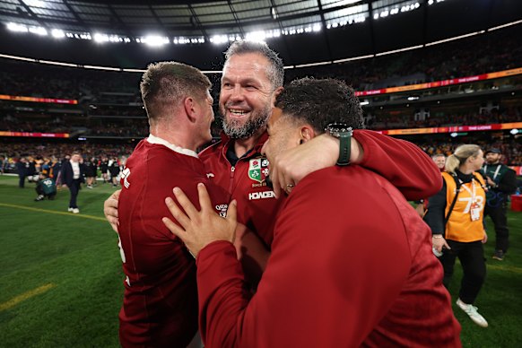 Andy Farrell, the British & Irish Lions head coach congratulates Owen Farrell (L) of the British & Irish Lions and Sione Tuipulotu