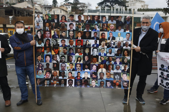 Members of the Uyghur community in Turkey hold banners 
in 2021 outside China’s consulate in Istanbul showing Uyghurs feared detained in camps in Xinjiang.