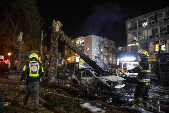 An Israeli firefighter works in the central Israeli town of Holon, where a rocket fired from the Gaza Strip hit. 