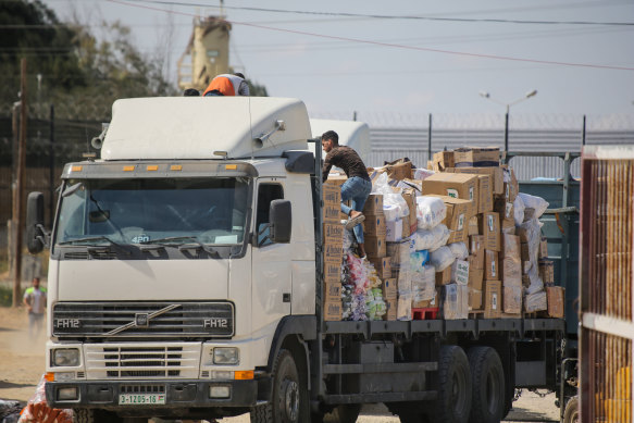 Humanitarian aid arrives through the Rafah land crossing into the Gaza Strip.