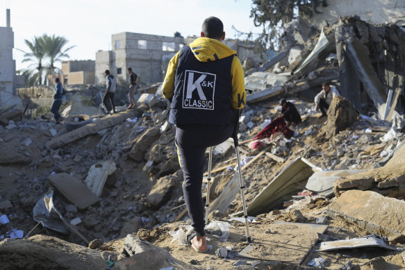 Palestinians look at the destruction by the Israeli bombardment of the Gaza Strip in Rafah.