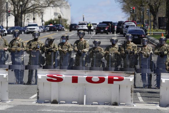Troops stand guard after the car crashed into a barrier near the Capitol.