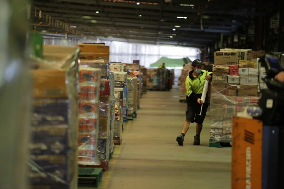 Workers at a Woolworths distribution centre in Larapinta, Brisbane.