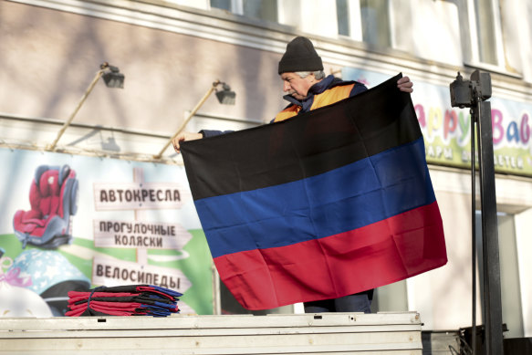 A municipal worker prepares to put up a Donetsk People Republic flag on a building in Donetsk, the territory controlled by pro-Russian militants, eastern Ukraine.