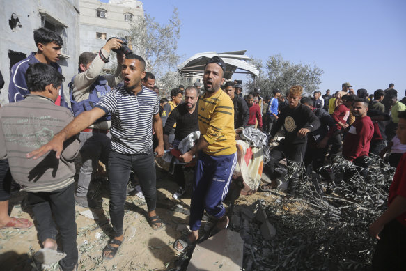 Palestinians evacuate survivors after an Israeli strike in Rafah in Gaza..