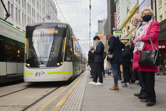 People wear face masks in Melbourne in July.