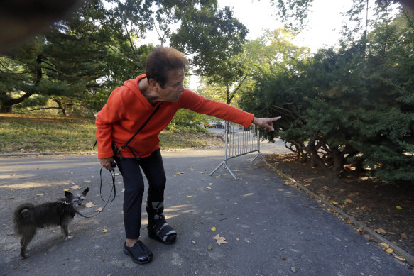 Florence Slatkin, with her dog Paco, points to the spot where she and a friend discovered a dead bear cub in New York’s Central Park on October 7, 2014.