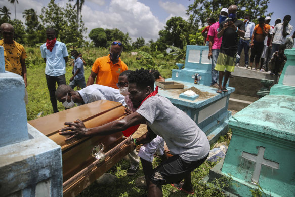 Francois Elmay is laid to rest in his family tomb in Les Cayes.