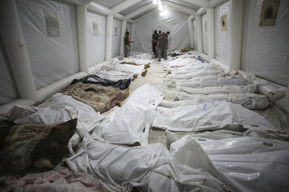 Bodies of Palestinians killed by an explosion at the Ahli Arab hospital are gathered in the front yard of the al-Shifa hospital in Gaza City.