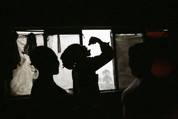 A man takes cough medicine, used as a drug, in Harare, where drug abuse brought on by the economic crisis is rampant.