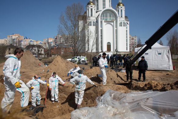 Forensic workers in Bucha, Ukraine, exhume bodies from mass grave after Russian forces retreated from the city.