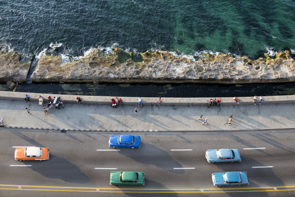 Vintage American cars along the Malecon in Havana.