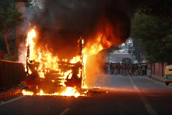 A bus goes up in flames during a protest against the Citizenship Amendment Act in New Delhi on Sunday.