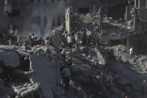 Palestinians look for survivors following an Israeli airstrike on the  Bureij refugee camp in the Gaza Strip.