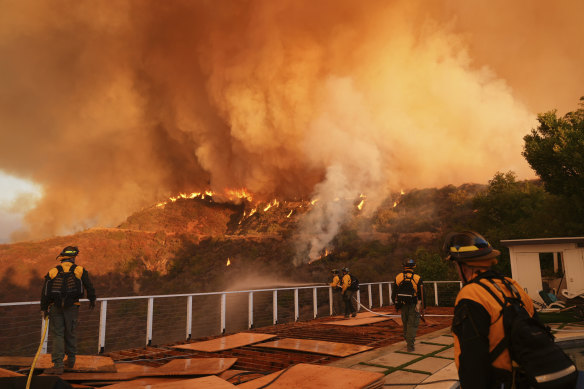 Fire crews monitor the Palisades fire in Mandeville Canyon at the weekend.