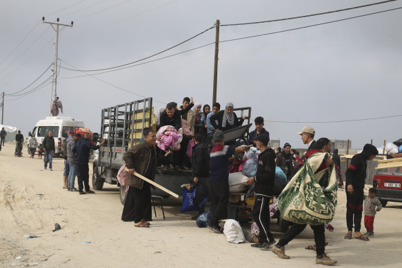 Palestinians fleeing the Israeli ground offensive arrive in Rafah.