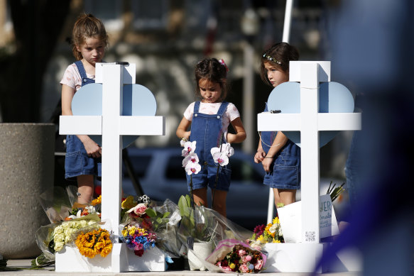 Children pay their respects at a memorial site for the victims killed in this week’s elementary school shooting in Uvalde, Texas, on Thursday.