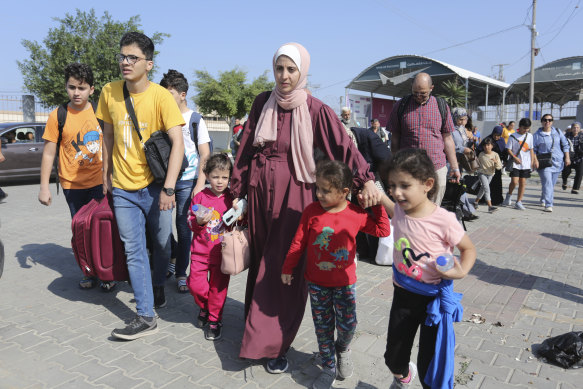 Palestinians cross to the Egyptian side of the border crossing with Gaza in Rafah.