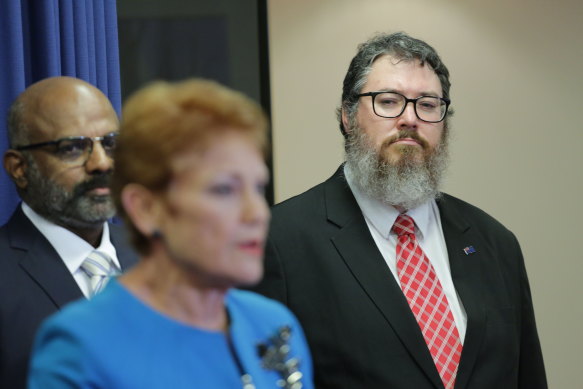 George Christensen looks on as One Nation leader Pauline Hanson announces his Senate candidacy for the party at the 2022 election.