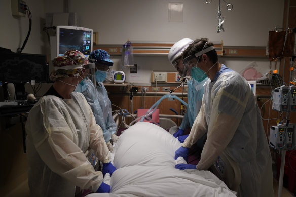 Medical workers prepare to move a COVID-19 patient at a hospital in Los Angeles.