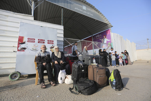 Palestinians wait at the border crossing between the Gaza Strip and Egypt in Rafah on Wednesday.