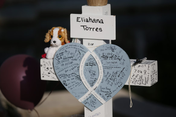 Eliahana Torres’ cross stands at a memorial site for the victims killed in this week’s shooting at Robb Elementary School.