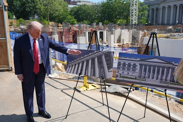 Trump, in May, showing reporters the latest plans for his ballroom.