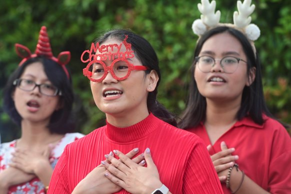 Students sing during a roadside Christmas carol service in Jakarta, Indonesia, last Christmas.
