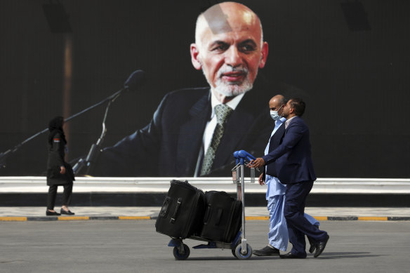 Passengers make their way to the Hamid Karzai international airport in Kabul on Saturday as Taliban forces advance towards the capital.