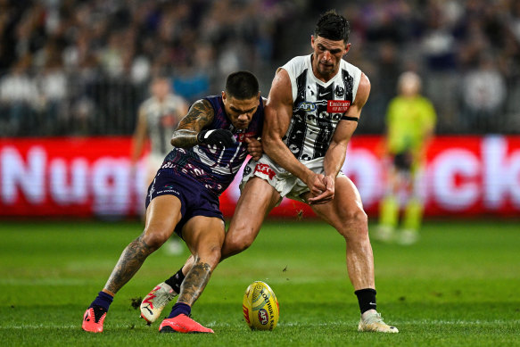 Scott Pendlebury of the Magpies competes for the ball with Michael Walters of the Dockers.