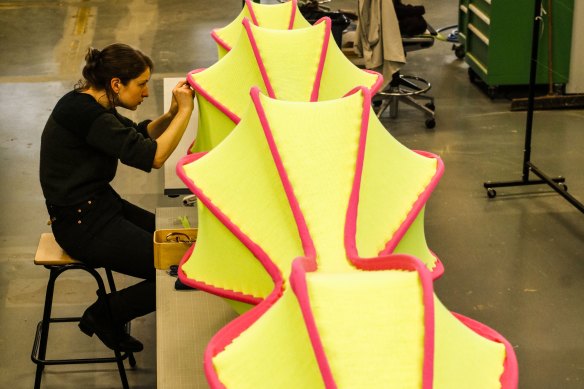 A technician constructs Leanne Zilka and Jenny Underwood’s “Knitted architecture” sculpture.