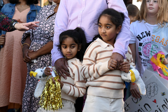 Sisters Kopika, right, and Tharnicaa with their parents Priya and Nades Murugappan at a press conference after they landed at the Thangool Aerodrome near Biloela on Friday.