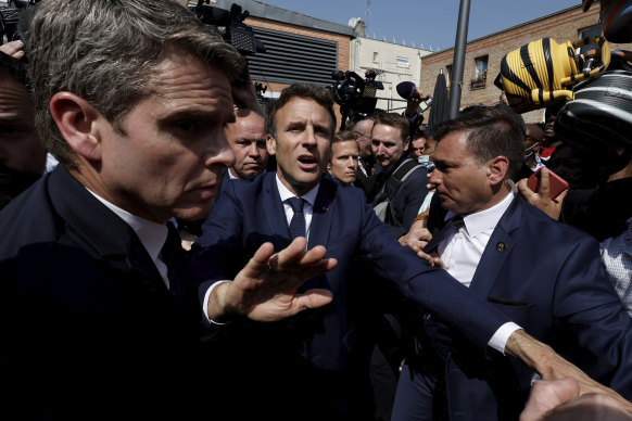 Newly re-elected French President Emmanuel Macron meets residents at the Saint-Christophe market square in Cergy.