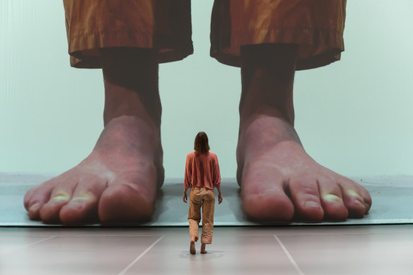 In Make Your Life Count, Sarah Aiken spends the first half dialoguing with a giant on-screen projection of herself.