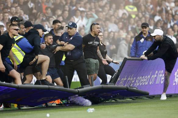 Fans storm the pitch during the match between Melbourne City and Melbourne Victory at AAMI Park.