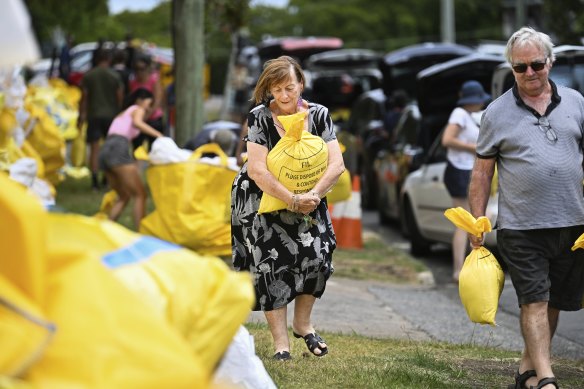 Brisbane residents collect sandbags on Monday.