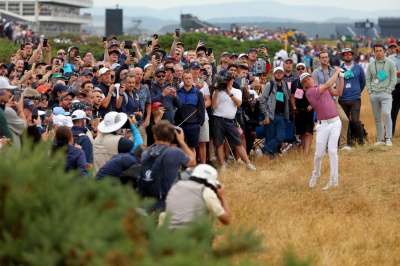 Cam Smith plays out of the rough at the 15th.