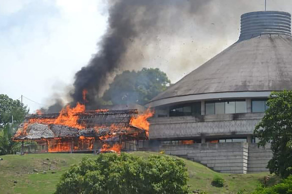 A building burns next to the Parliament building in Honiara on Wednesday.