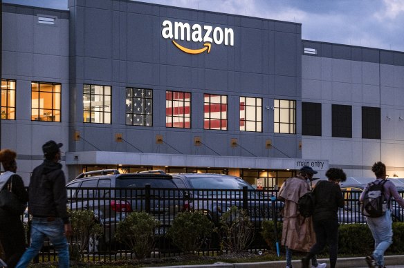 People arrive for work at the Amazon distribution center in the Staten Island borough of New York.