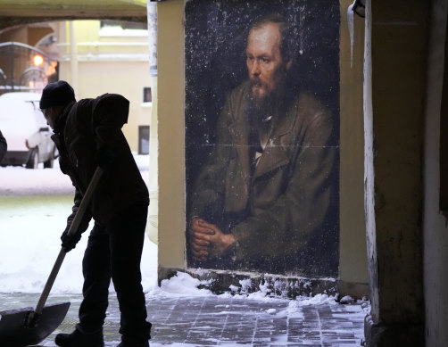 A worker clears snow from a portrait of Fyodor Dostoevsky on a wall near the apartment-museum where he lived in St Petersburg.