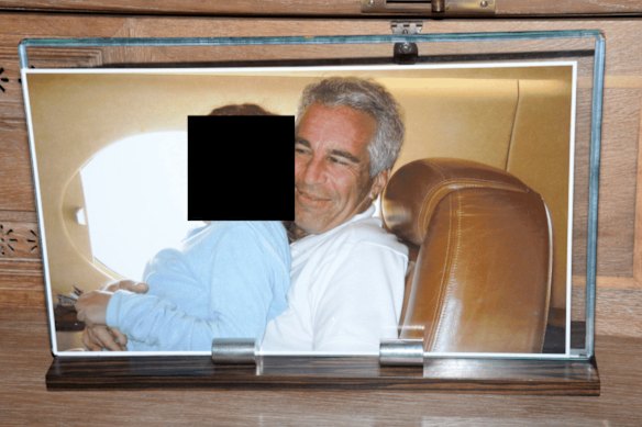 A framed photograph of Epstein with a female on his lap, documented during a search of his home on Little St James island in 2019.