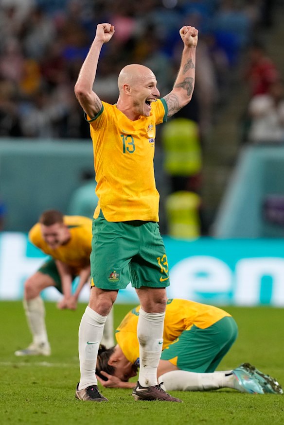 Aaron Mooy and the Socceroos celebrate victory.